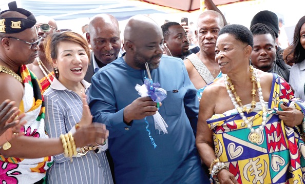 Michael Okyere Baafi (2nd from right), a Deputy Trade and Industry Minister, assisted by Yang Yang (2nd from left), MD, Zonda Tec, and traditional rulers to cut the tape for the opening of the new branch